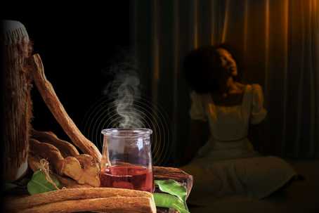 Trauma Healing. A steaming glass jar filled with a crimson herbal ayahuasca concoction, surrounded by dried ayahuasca bark and leaves on a rustic wooden table. In the background, a female-presenting person with an afro hairstyle sits on the floor, draped in soft, warm light, their back to the camera, gazing into the distance.