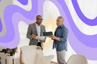 Surrender in Psychedelic Experiences. Two people standing and talking in what appears to be a therapy consultation room. There are graphics of wavy soft purple lines in the background.