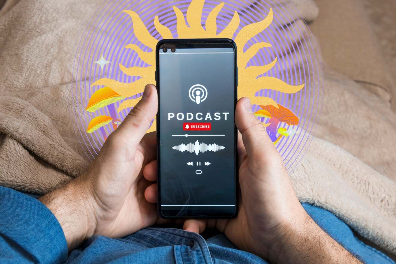 Psychedelic Podcast. View of a person's hands from their perspective, holding a mobile phone in their hands, with the screen showing that a podcast is playing. The person appears to be sitting with a beige fluffy blanket on their lap, and they are wearing a button-down denim shirt. Behind the phone is a flat-color soft yellow sun shape, and behind that, a purple spiral of concentric circles. There are some graphics of psychedelic mushrooms on behind both sides of the person's hands.