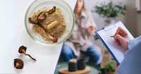 Microdosing in Psychotherapy. Left Side: A bowl with ground mushroom powder and whole dried mushrooms, with a capsule in the powder, likely containing mushroom powder or another supplement. The dried mushrooms resemble psilocybin mushrooms, known for their psychoactive properties. Right Side: A person sits casually while someone in the foreground writes notes on a clipboard, suggesting a therapy session. The image may imply a connection between psychedelic-assisted therapy and the use of mushrooms, possibly psilocybin, in mental health treatment or research.